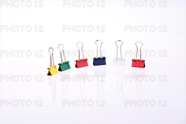 Colored paper clips on a white background