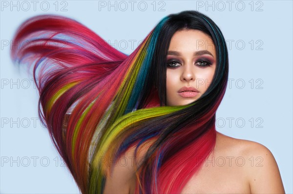 Portrait of beautiful woman with multi-colored hair and creative make up and hairstyle