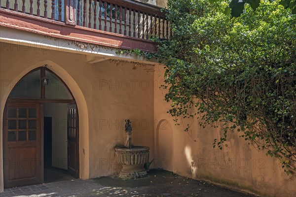 Dolphin rider fountain in a historic courtyard