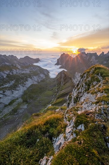 View over Saentis mountains into the valley of Meglisalp at sunrise