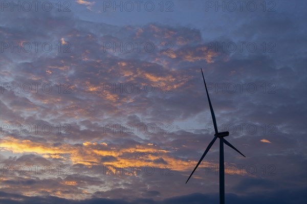 Wind power plant in front of evening sky