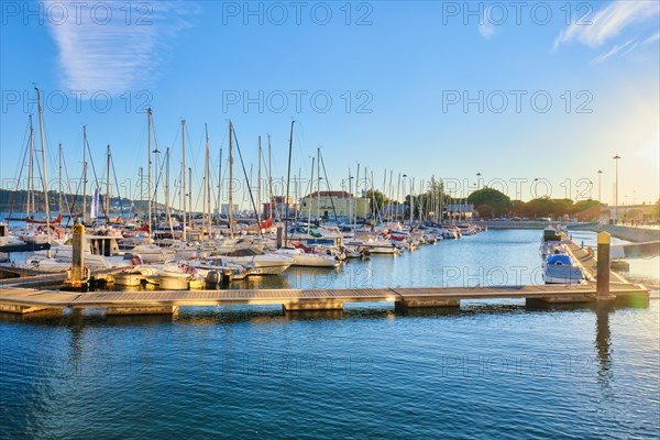 Lisbon marina on Tagus river with moored yachts and boats on sunset. Belem