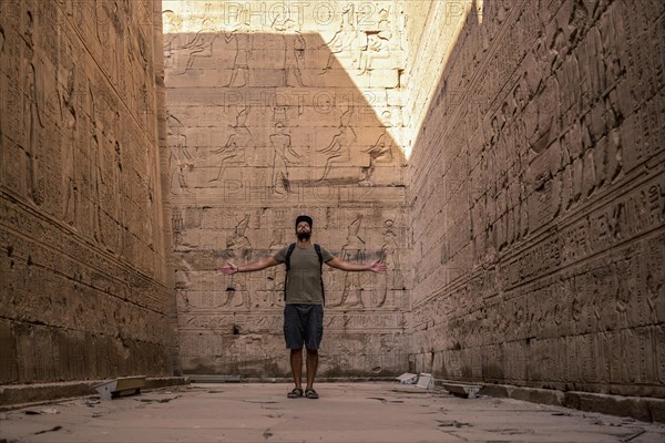 A young tourist visiting the beautiful temple of Edfu in the city of Edfu