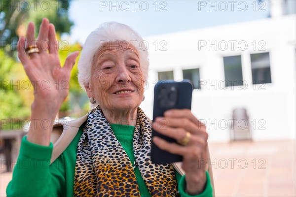 An elderly man in the garden of a nursing home or retirement home on a sunny summer day