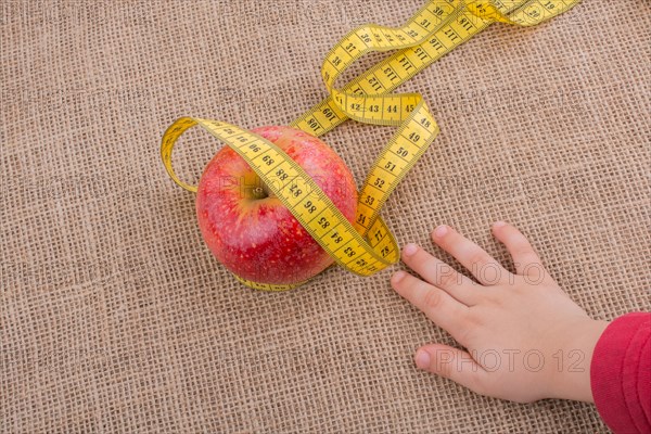 Health and diet concept with apple with a measurement tape