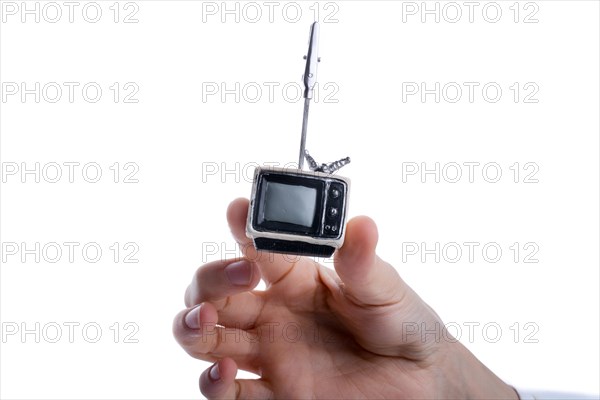 Child holding a tv set n his hand on a white background