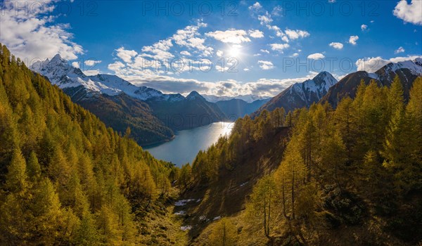 Aerial view over the autumnal forest at Lago di Luzzone in Valle di Blenio