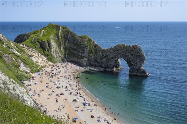 Bathing beach at the famous rock bridge Durdledoor