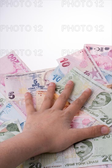 Hand holding Turksh Lira banknotes on white background