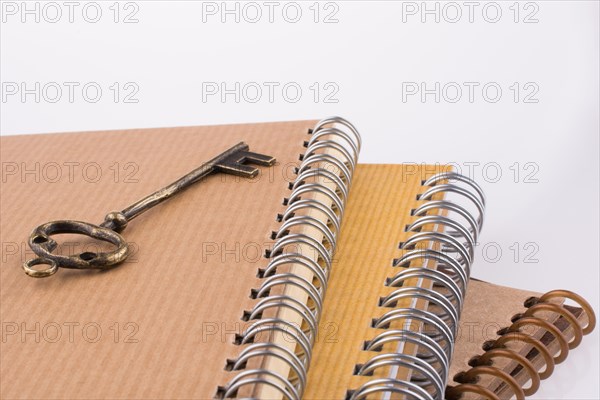 Metal Key on spiral notebooks
