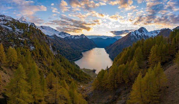 Aerial view after sunset over the autumnal forest at Lago di Luzzone in Valle di Blenio