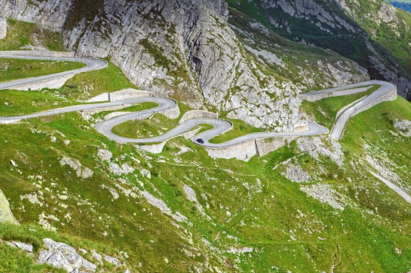 View from elevated position on partial view of old southern pass road Tremola south ramp with serpentines tight curves hairpin bends on steep mountain slope of Gotthard Pass