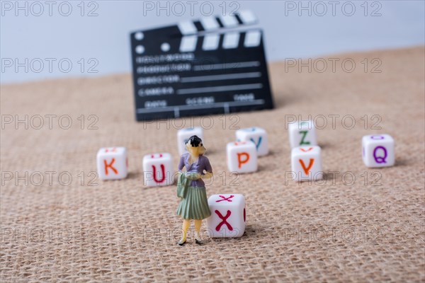 Colorful letter cubes beside a director clapper board