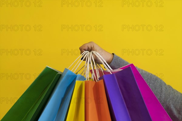 Shopping bags in the woman hands. Joy of consumption. Purchases