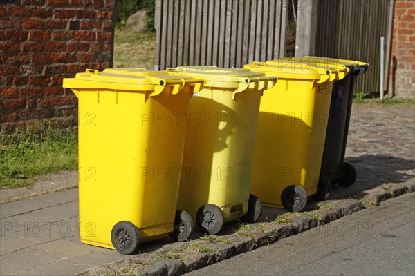 Yellow bins for plastic waste standing on the street