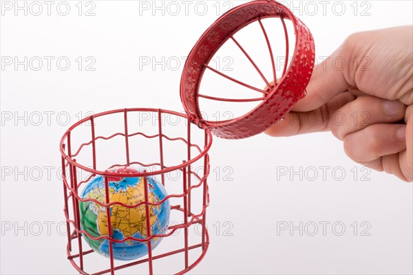 Small globe trapped in a red birdcage