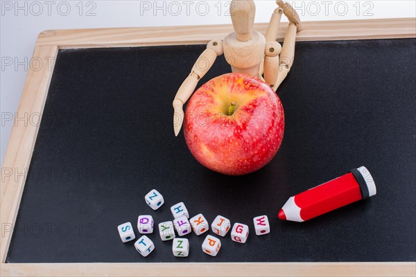 Back to school theme with a red apple and board