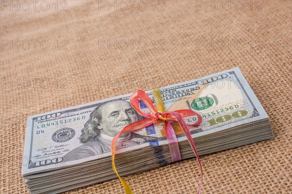 Banknote bundle of US dollar tied with colorful a ribbon