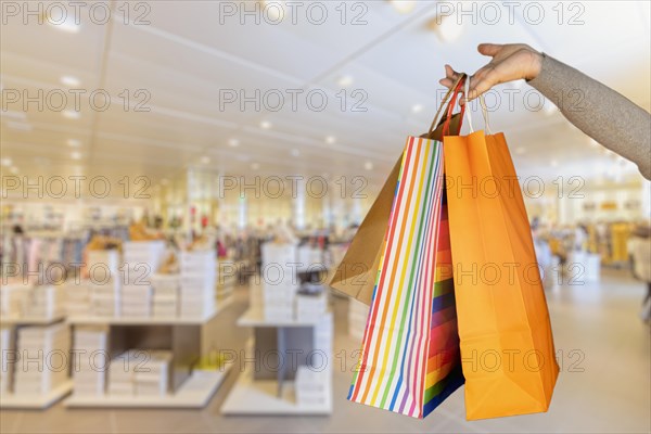 Shopping bags in the woman hands. Joy of consumption. Purchases