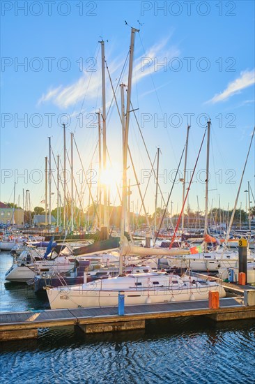 Lisbon marina on Tagus river with moored yachts and boats on sunset. Belem