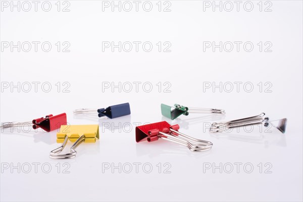 Colored paper clips on a white background