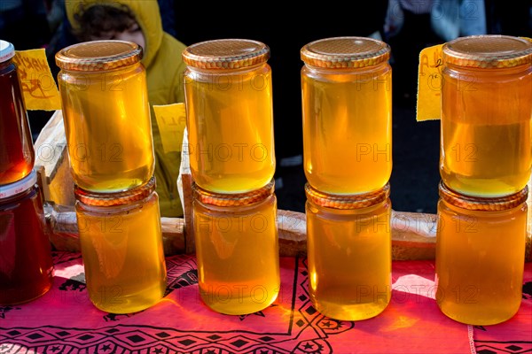 Glass jar of full of fresh honey with lid