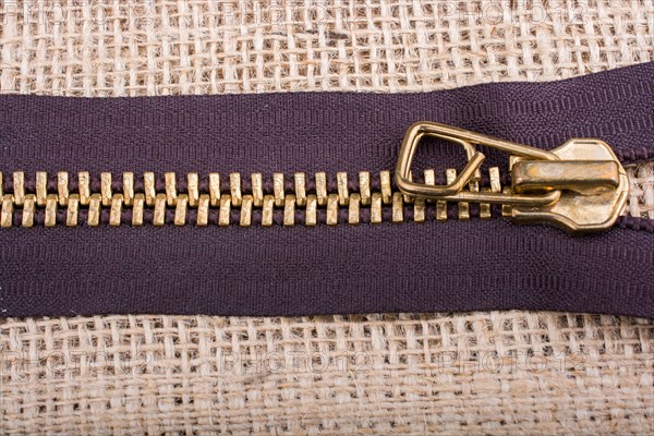Closeup of a colorful zipper on linen canvas
