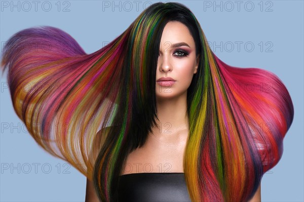 Portrait of beautiful woman with multi-colored hair and creative make up and hairstyle