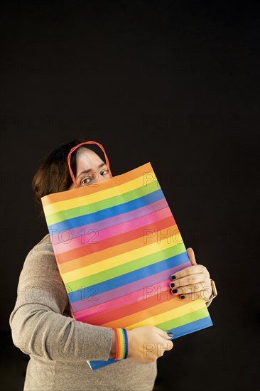 Woman holding lgbt bag. Joy of consumption. Purchases