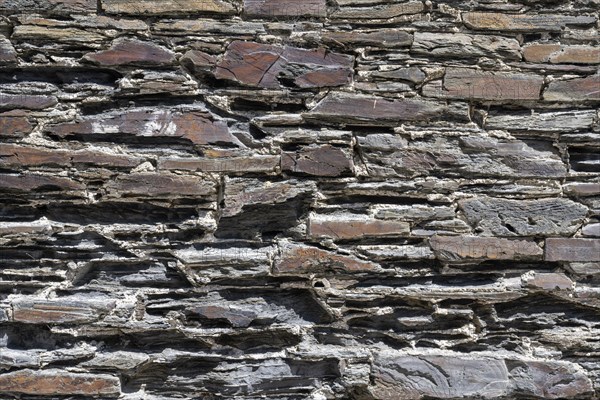 Slate slabs stacked to form a house wall