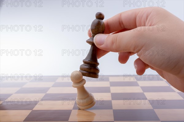 Person playing chess game making a move on board