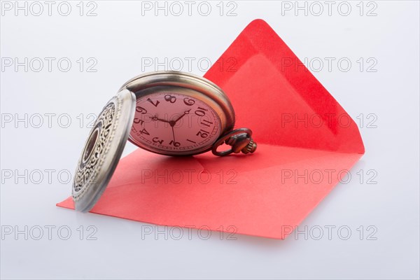 Mechanical pocket watch on a red envelope