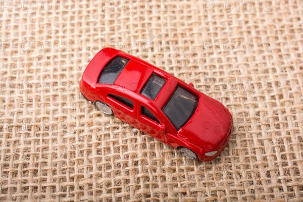 Colorful little toy car on canvas background