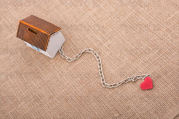 Model house and chain with a heart on canvas
