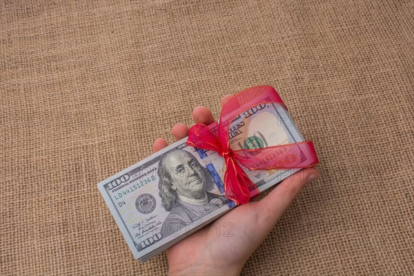 Banknote bundle of US dollar tied with colorful a ribbon