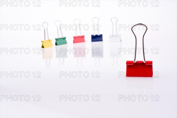 Colored paper clips on a white background