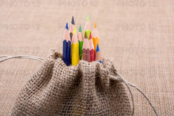 Color Pencils in a linen sack on canvas