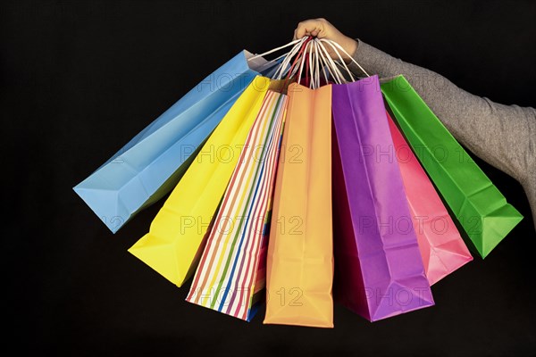 Shopping bags in the woman hands. Joy of consumption. Purchases