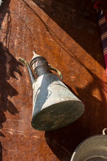 Ancient metal jug in oriental style in antique market