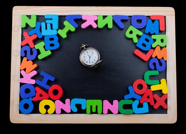 Pocket watch and colorful Letters of Alphabet made of wood