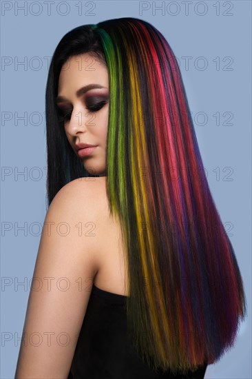 Portrait of beautiful woman with multi-colored hair and creative make up and hairstyle