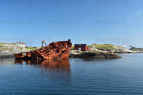 Rusty shipwreck on the Atlantic Strait in Norway