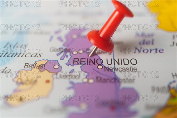 United kingdom marked with a red thumbtack on a map with an out-of-focus background