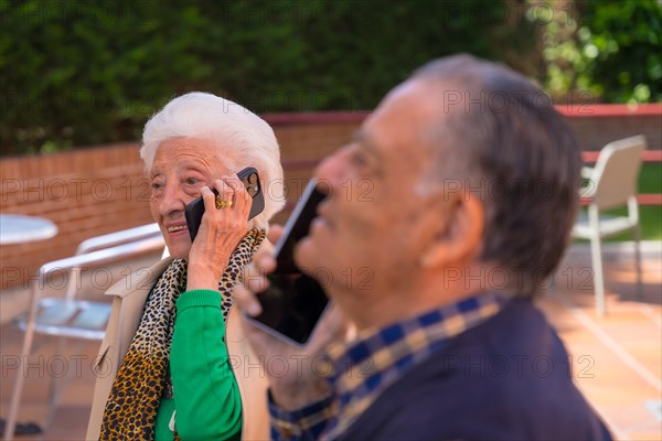 Two elderly people in the garden of a geriatric retirement home