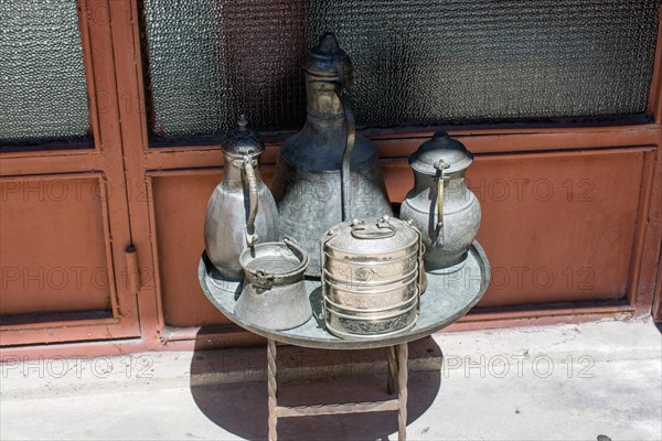 Ancient metal jug in oriental style in antique market