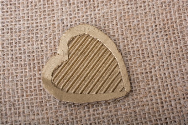 Heart shaped cut out of a brown cardboard