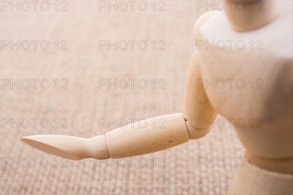 Wooden dolls of a man posing on canvas