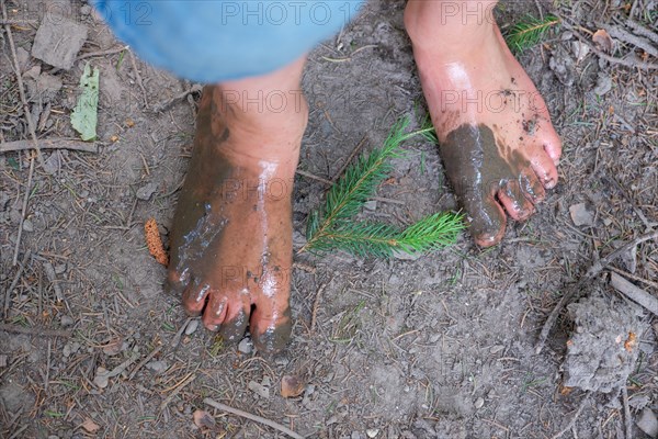 Feet of a child on the Wuppenau barefoot path on Nollen