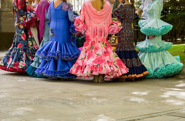 Group of women with unrecognizable backs wearing traditional dress from andalucia