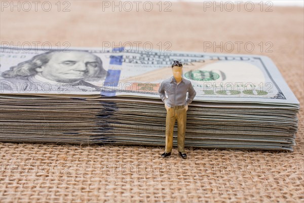 Man figurine found beside the bundle of US dollar banknote